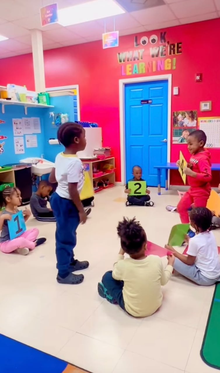 Children learning with number cards